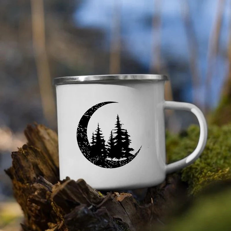 White mug with black crescent moon and trees design on a natural background